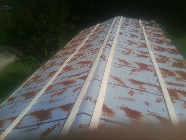 Rusted metal roof panels with new wood purlins before replacement — Storm Damage Roof Repair in Ware Shoals by Roofing Brothers