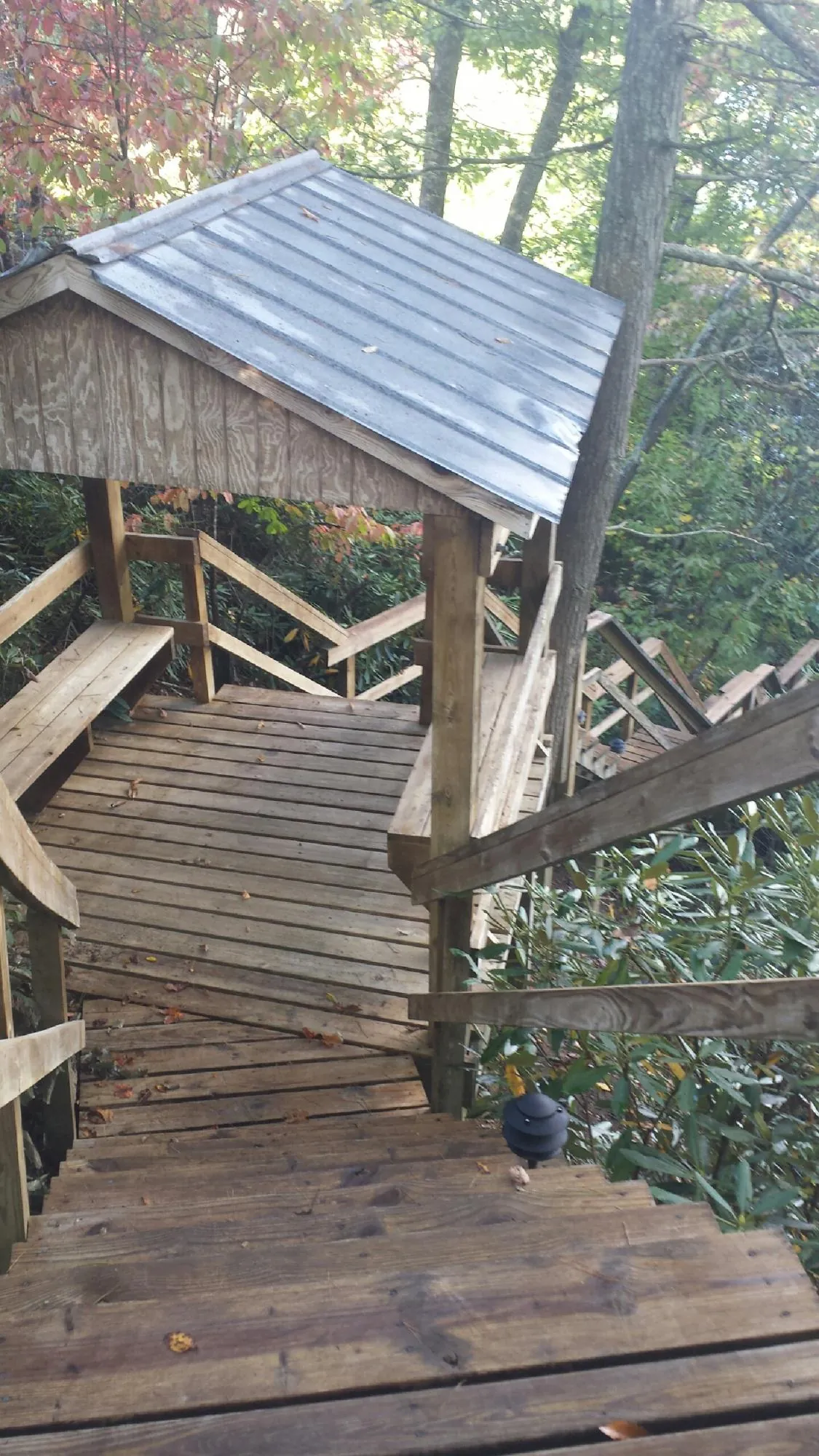 Metal roofed shelter over wooden steps on a wooded walkway — Skylight Repair & Installation work by our crew in Ware Shoals