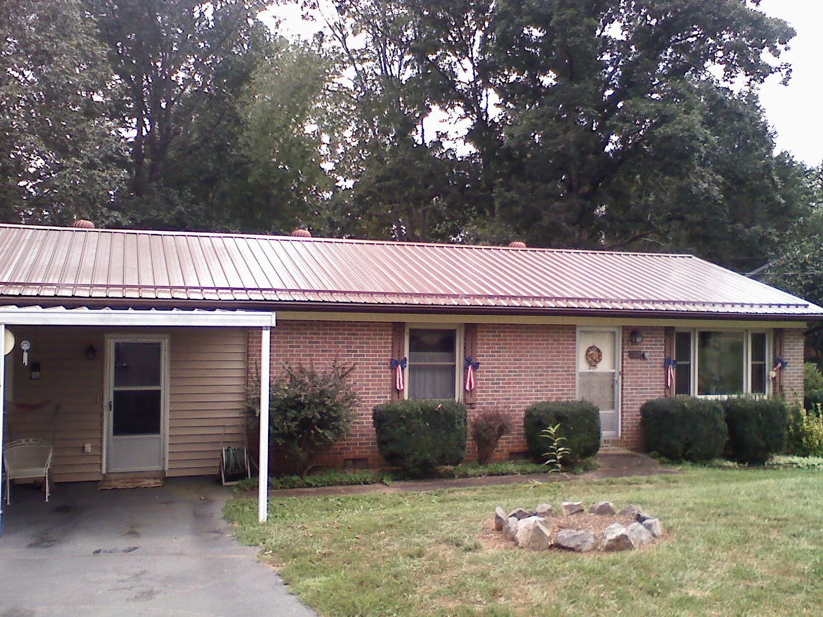 Bronze metal roof and carport on a brick ranch home — Roof Repair work by our crew in Ware Shoals